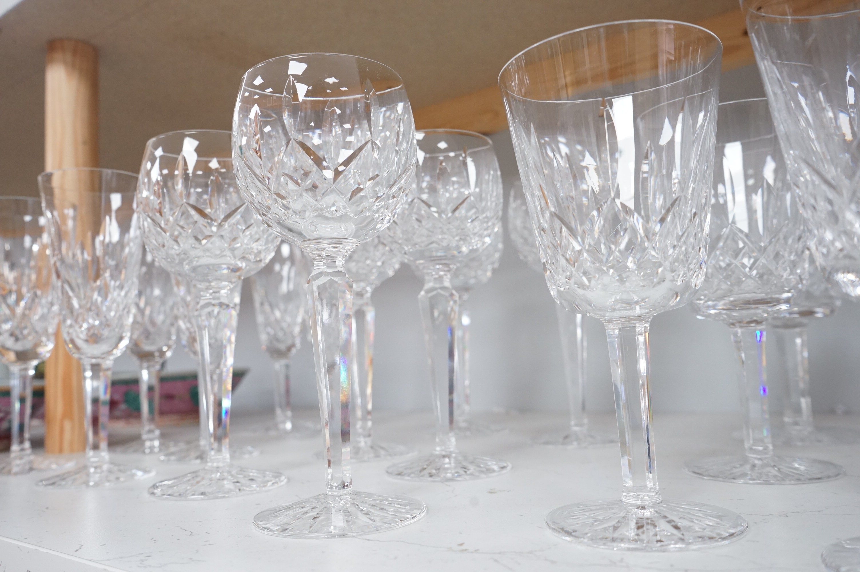 Twenty two Waterford Crystal company wine glasses and a decanter, 33cm